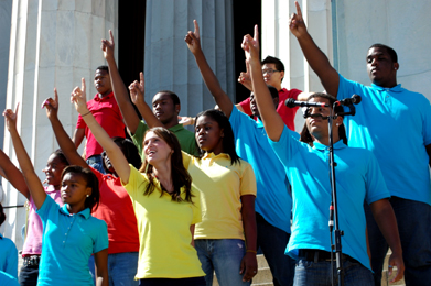 Image of colourful young people in front of Lincoln Memorial pointing